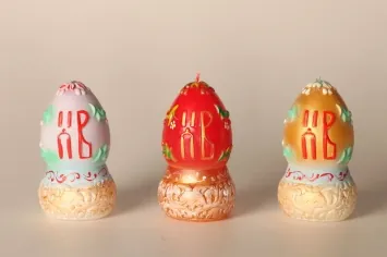 Easter candle egg on carved stand